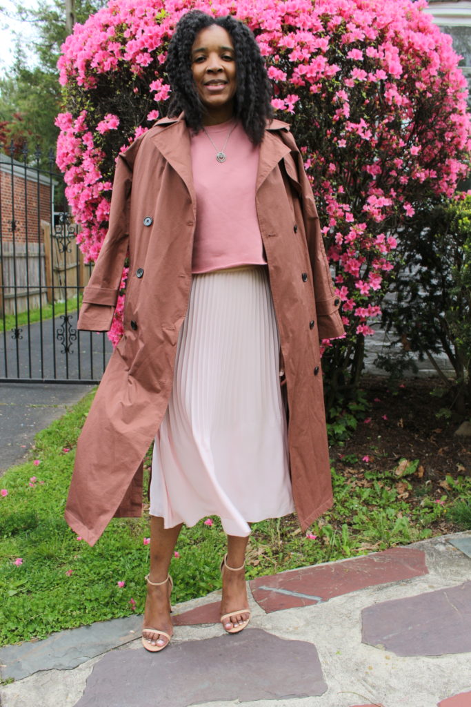 trench coat styled with pleated midi skirt crop sweatshirt and sandals 